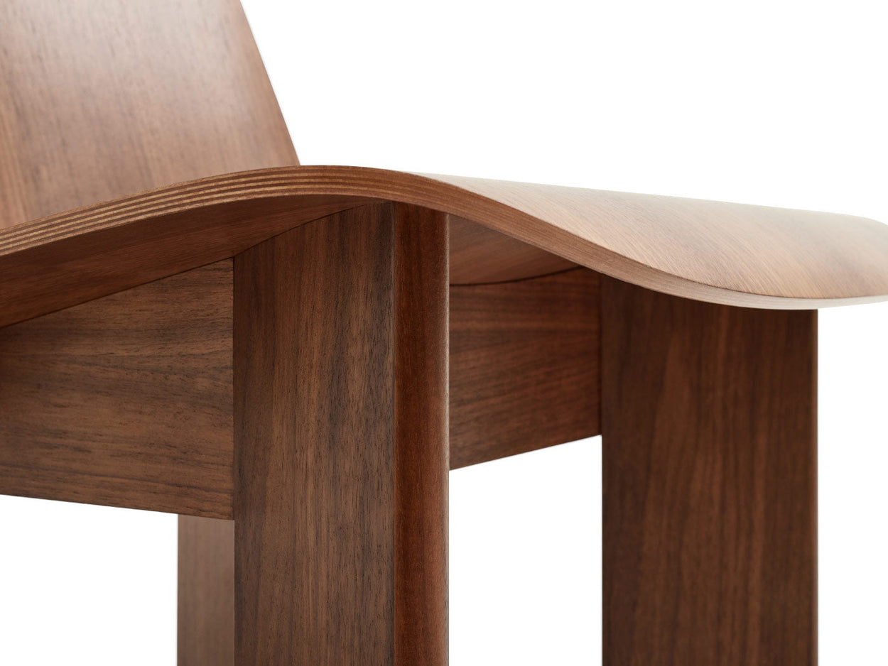 Close-up of a walnut Chisel lounge chair by HAY, showing the curvature of the seat.