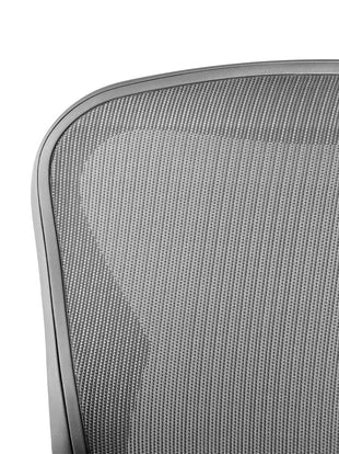 Close-up of the mesh pelicle suspension on the back of a graphite Aeron office chair