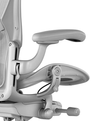 Close-up of seat adjustment controls on a mineral Aeron office chair